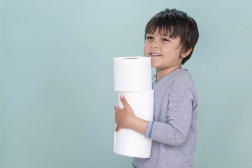isolated-side-view-portrait-of-cute-kid-holding-toilet-roll-on-blue-background-child-boy-with-smiling-face-while-carrying-stack-of-toilet-paper-01-01